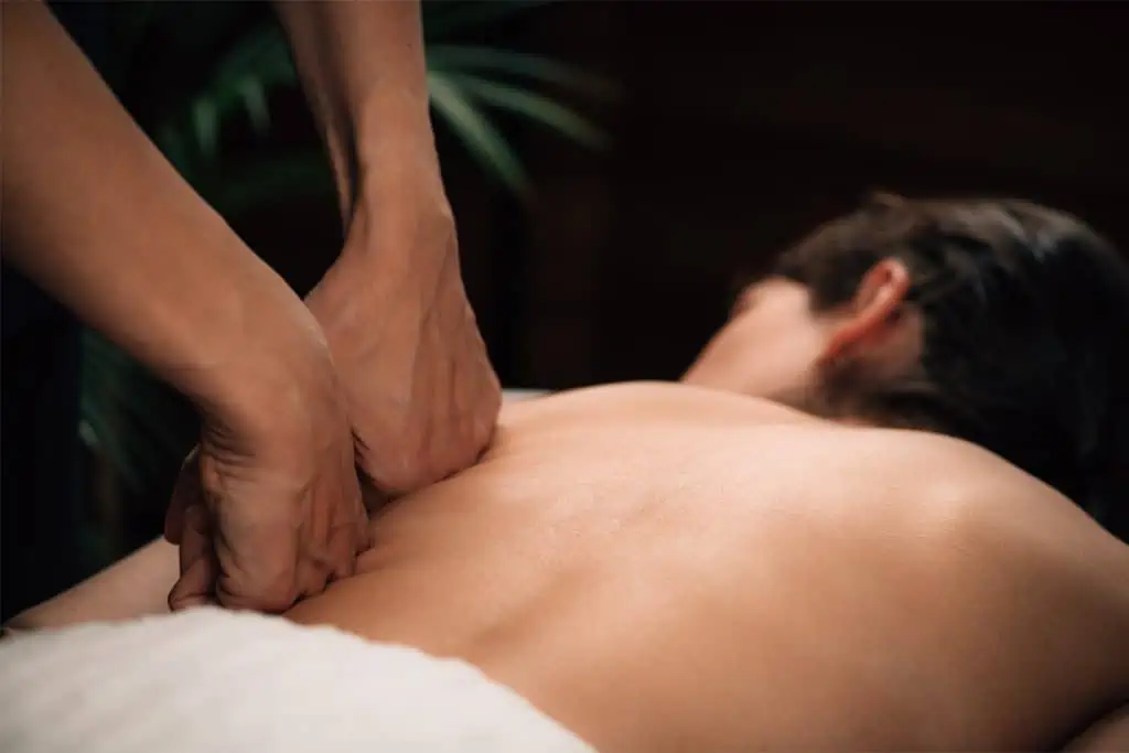 A woman enjoying a relaxing back massage at a spa.