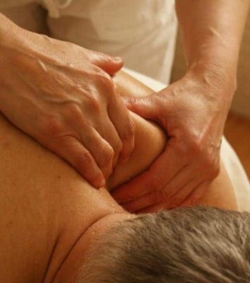 A man receiving a soothing massage therapy in Ottawa to relax his back muscles.